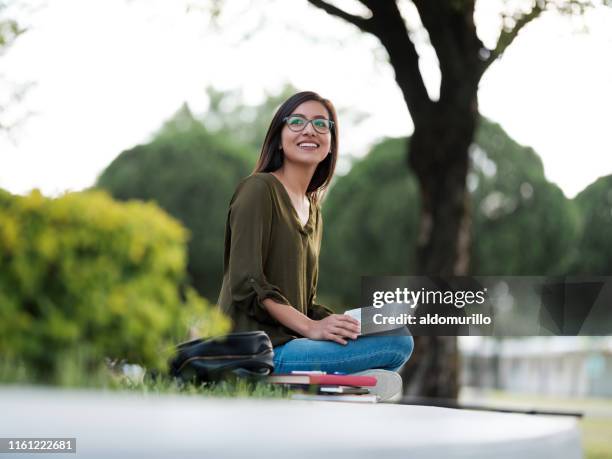 young woman meditating on the bible outdoors - christian college stock pictures, royalty-free photos & images