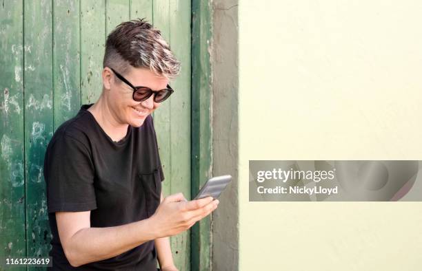 checking her social media updates - weekend update stock pictures, royalty-free photos & images