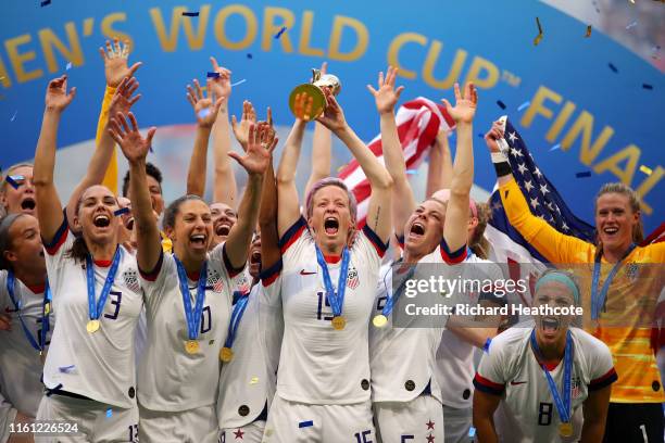 Megan Rapinoe of the USA lifts the trophy as USA celebrate victory during the 2019 FIFA Women's World Cup France Final match between The United State...