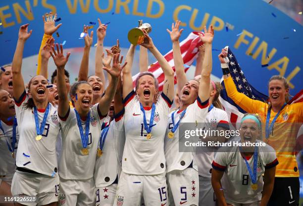 Megan Rapinoe of the USA lifts the trophy as USA celebrate victory during the 2019 FIFA Women's World Cup France Final match between The United State...