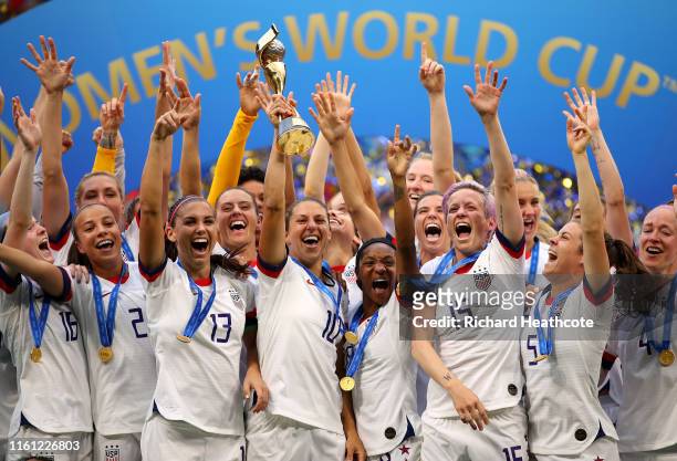 Carli Lloyd of the USA lifts the trophy as USA celebrate victory during the 2019 FIFA Women's World Cup France Final match between The United State...