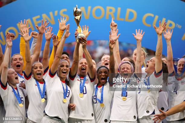 Carli Lloyd of the USA lifts the trophy as USA celebrate victory during the 2019 FIFA Women's World Cup France Final match between The United State...