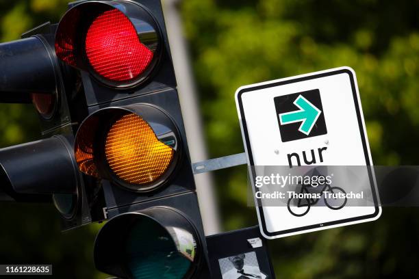 Green arrow for cyclists is mounted next to a traffic light on August 12, 2019 in Berlin, Germany.