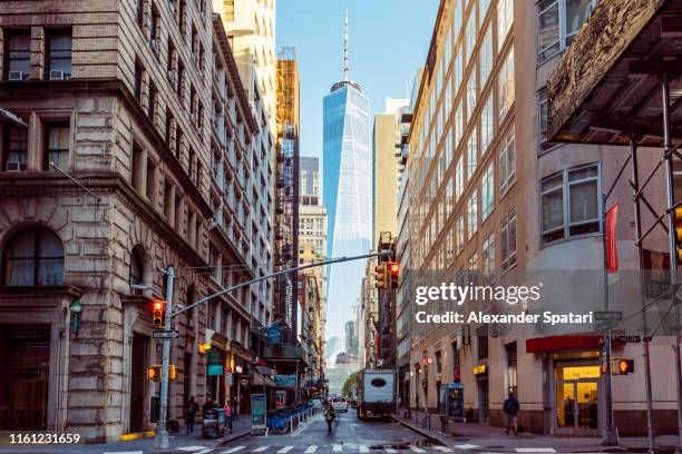 street in downtown manhattan with one world trade center in the center, new york, usa - financial district nyc stock pictures, royalty-free photos & images