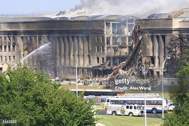 Smoke comes out from the Southwest E-ring of the Pentagon building September 11, 2001 in Arlington, Va., after a plane crashed into the building and...