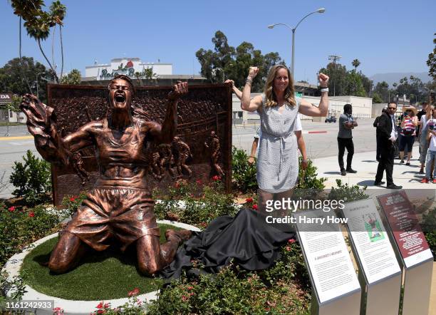 Brandi Chastain poses with statue of herself during an unveiling of a statue honoring the United States win at 1999 Women’s World Cup on July 10,...
