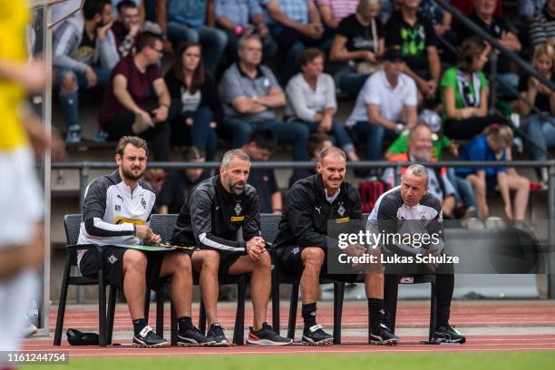 Coach Rene Maric , Head Coach Marco Rose, coach Alexander Zickler and coach Frank Geideck sit on the bench during the pre-season friendly match...