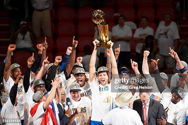 Finals: Dallas Mavericks Dirk Nowitzki victorious, holding Larry O'Brien Championship trophy with teammates after winning Game 6 and championship...