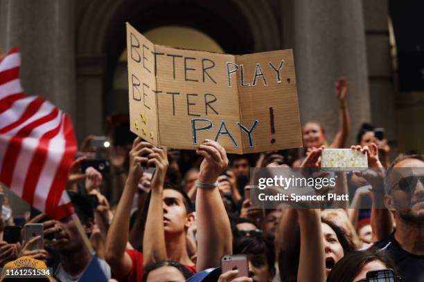 People cheer as members of the US Women's National Soccer Team travel down the "Canyon of Heroes" in a ticker tape parade on July 10, 2019 in New...