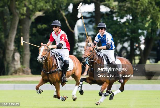 Prince William, Duke of Cambridge and Prince Harry, Duke of Sussex play during The King Power Royal Charity Polo Day at Billingbear Polo Club on July...