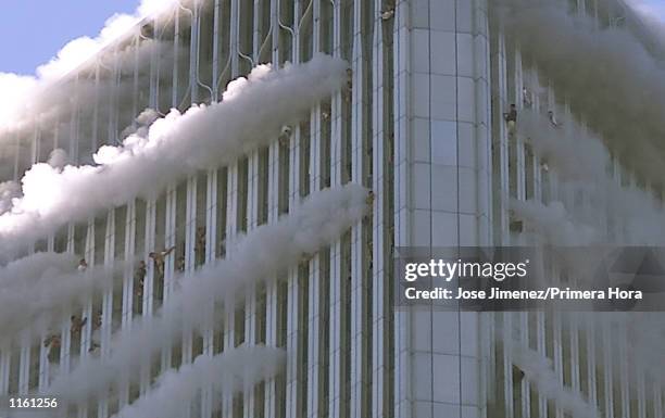 People hang from windows of World Trade Center after two planes hit the building September 11, 2001 in New York City.