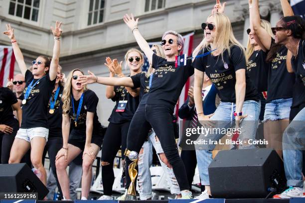 Members of the USA Women's National Soccer Team stand in front of the 2019 FIFA World Cup Trophy and dance after the City Hall Ceremony. Each member...