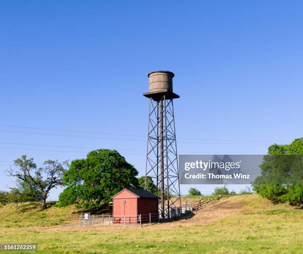 water tower and shack - water tower storage tank stock pictures, royalty-free photos & images