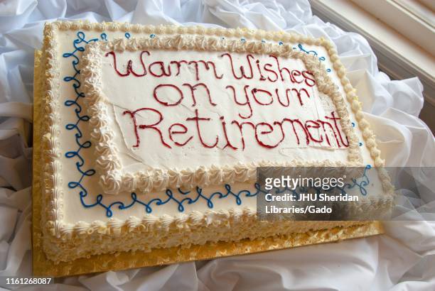 High-angle shot of a cake with the sentiment "Warm Wishes on your Retirement, " during a retirement party for Peter Petersen, a professor in the...