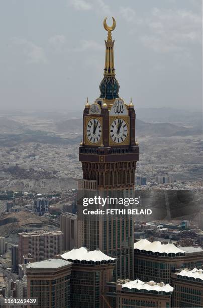 This picture taken on August 12, 2019 shows an aerial view the Abraj al-Bait Mecca Royal Clock Tower with its world-record-holding 45 meter diameter,...