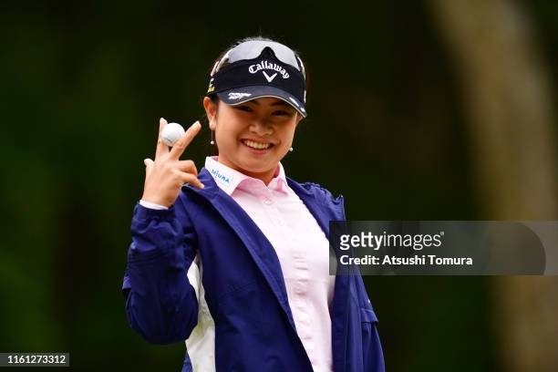 Yui Kawamoto of Japan celebrates after picking up her hole-in-one ball on the 11th green during the first round of the Nippon Ham Ladies Classic at...