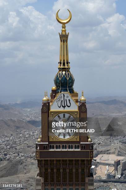 This picture taken on August 12, 2019 shows an aerial view the Abraj al-Bait Mecca Royal Clock Tower with its world-record-holding 45 meter diameter,...