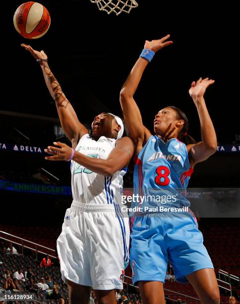 Cappie Poindexter of the New York Liberty lays up a shot against Iziane Castro Marques of the Atlanta Dream in the first half on June 14, 2011 at the...