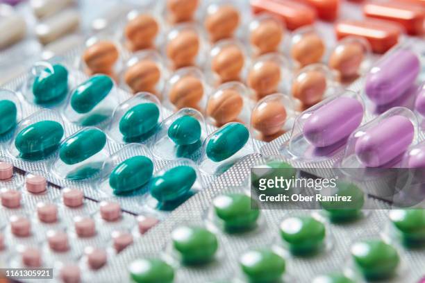 blisters of medicine pills, capsules, tablets over a color background - blister package stock pictures, royalty-free photos & images