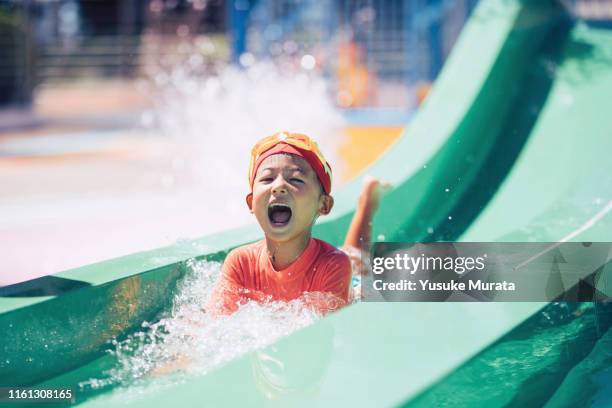 little girl playing at the pool - asian water splash stock-fotos und bilder