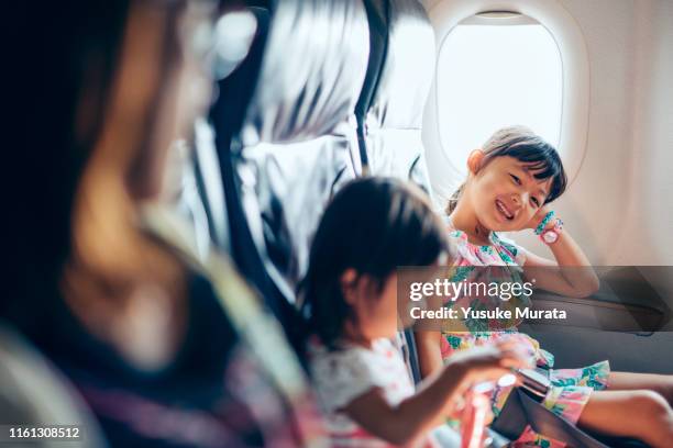 little girl portrait with smiling on airplane - 日本人　空港 ストックフォトと画像