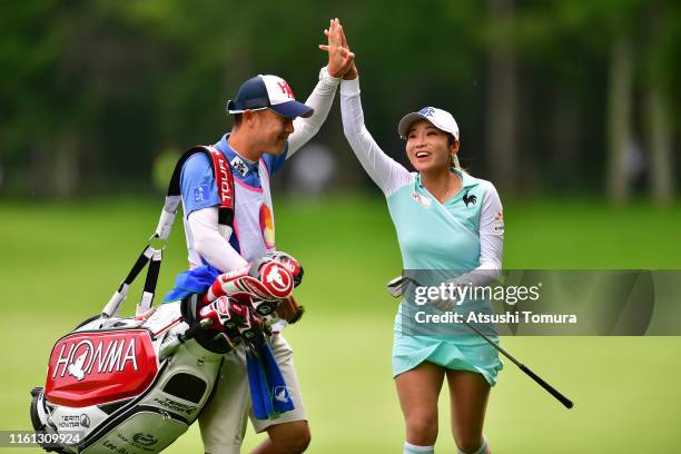 Bo-Mee Lee of South Korea celebrates after making an eagle with her caddie on the 15th hole during the first round of the Nippon Ham Ladies Classic...