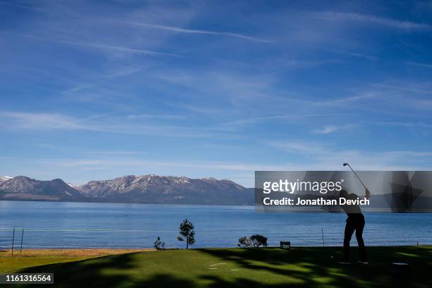 Player tees of on the 17th hole along Lake Tahoe during a practice round of the American Century Championship at Edgewood Tahoe Golf Course on July...