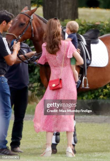 Catherine, Duchess of Cambridge and Prince Louis of Cambridge attend the King Power Royal Charity Polo Match, in which Prince William, Duke of...
