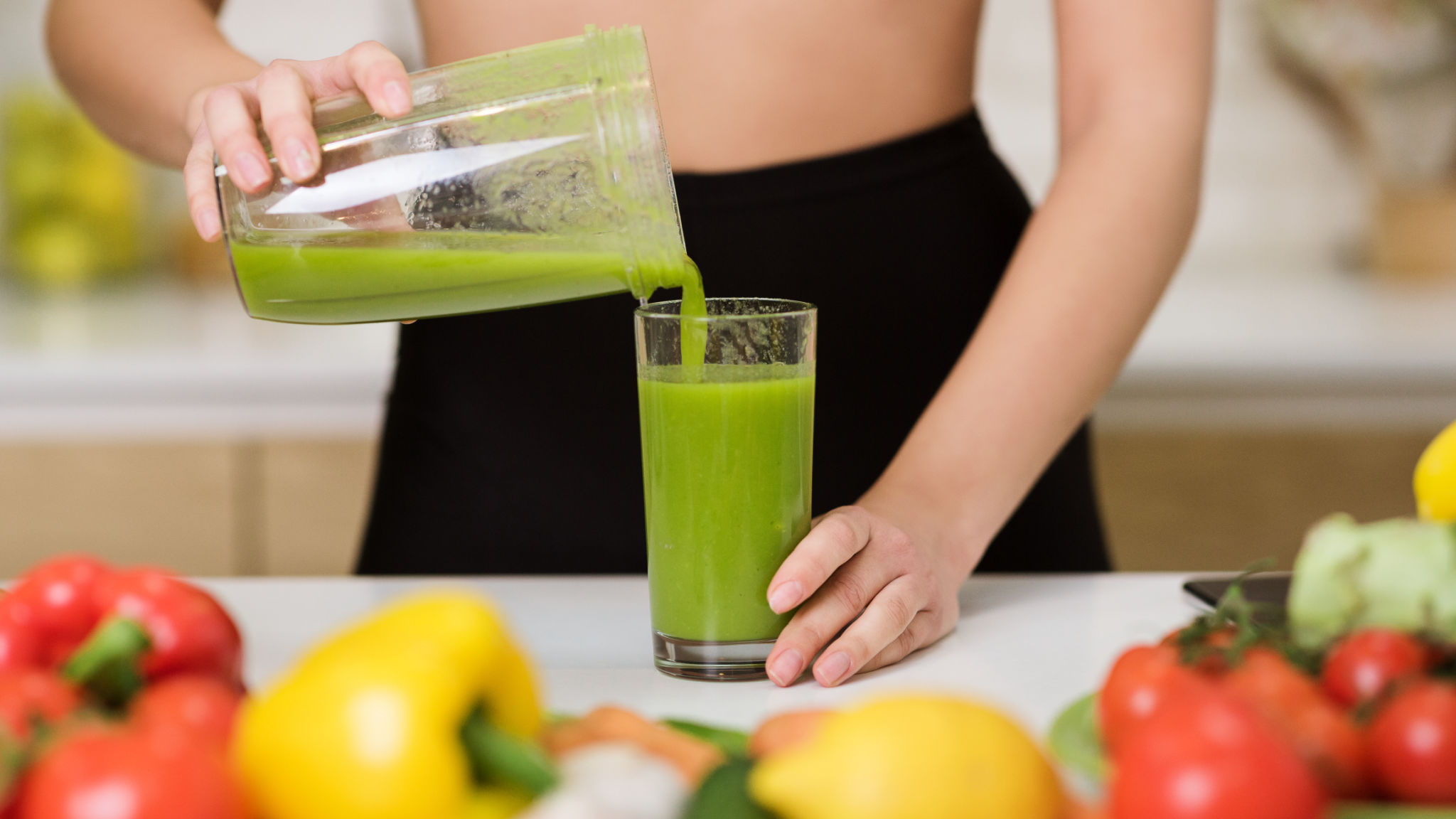 Healthy eating. Woman pouring detox shake to glass Healthy eating. Woman pouring detox shake to glass