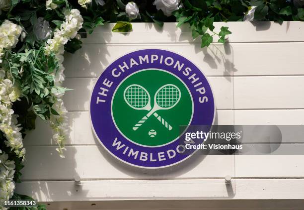 The Wimbledon logo surrounded by flowers during Day Ten of The Championships - Wimbledon 2019 at All England Lawn Tennis and Croquet Club on July 11,...