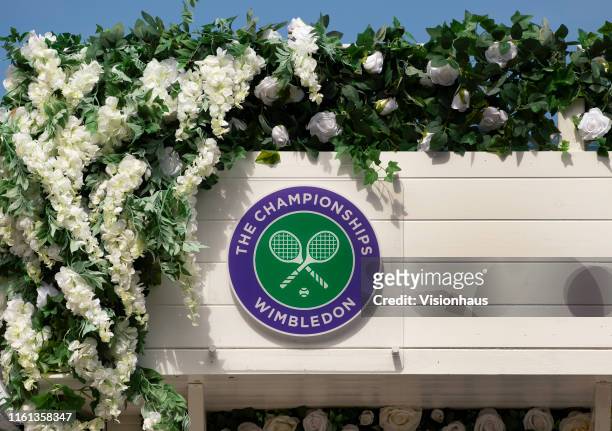 The Wimbledon logo surrounded by flowers during Day Ten of The Championships - Wimbledon 2019 at All England Lawn Tennis and Croquet Club on July 11,...