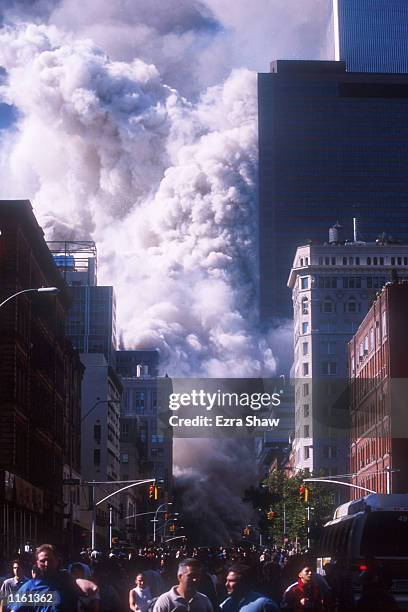 People run away from the World Trade Center's twin towers after they collapsed following being struck by a commerical airliner in a suspected...