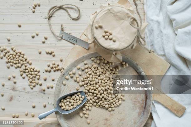 soy beans on wooden background - soybean stock-fotos und bilder
