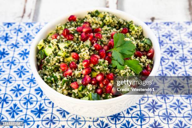 bulgur herbs tabbouleh with pomegranate seeds - slätpersilja bildbanksfoton och bilder