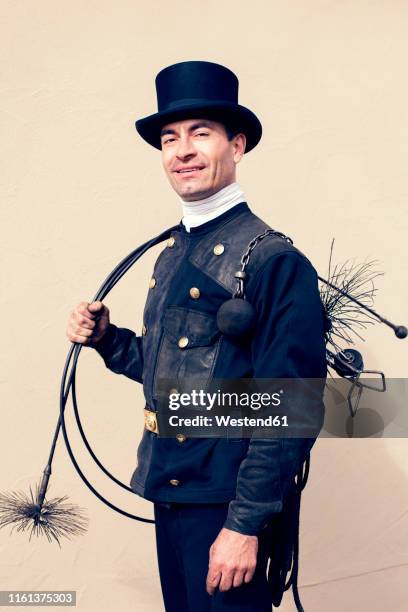 portrait of smiling chimney sweep - chimney sweep stock pictures, royalty-free photos & images