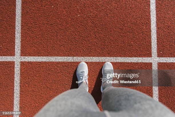 closeup of sportswoman feet on racetrack - pov shoes stock-fotos und bilder