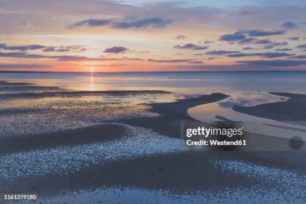 sunrise over north sea, sylt, germany - waddenzee stockfoto's en -beelden