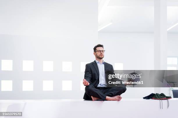 businessman doing yoga in office - businessman meditating stock pictures, royalty-free photos & images