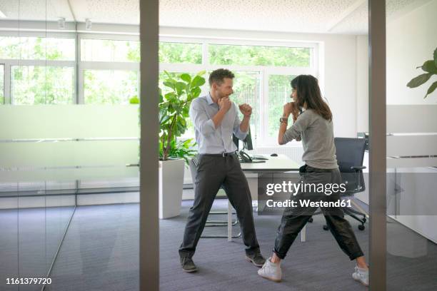 businessman and businesswoman fighting in office - table fight stock pictures, royalty-free photos & images
