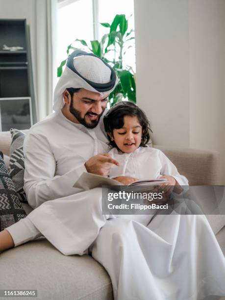 Arabic Language Father Arab Dad And Son Reading A Book For Homework At Home High-Res Stock ...