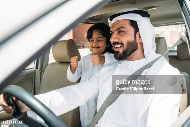 arab dad in the car with his son - happy arab family on travel stock pictures, royalty-free photos & images