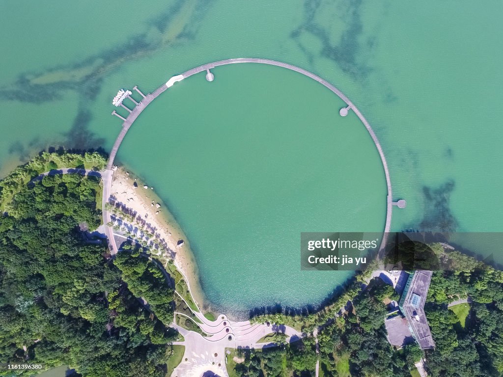Aerial View of a Circular Lake Pedestrians in Taihu Lake