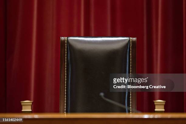a leather chair in a courtroom - empty courtroom stock-fotos und bilder