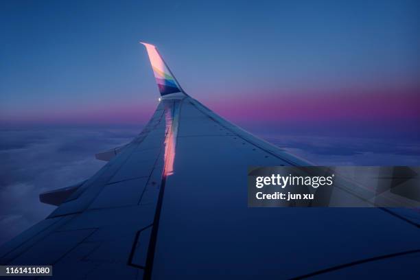 beautiful sunrise clouds outside the airplane window - aerospace abstract stock pictures, royalty-free photos & images