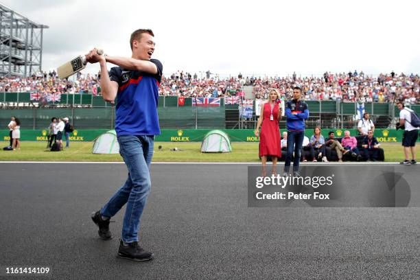 Daniil Kvyat of Russia and Scuderia Toro Rosso plays cricket on track during previews ahead of the F1 Grand Prix of Great Britain at Silverstone on...