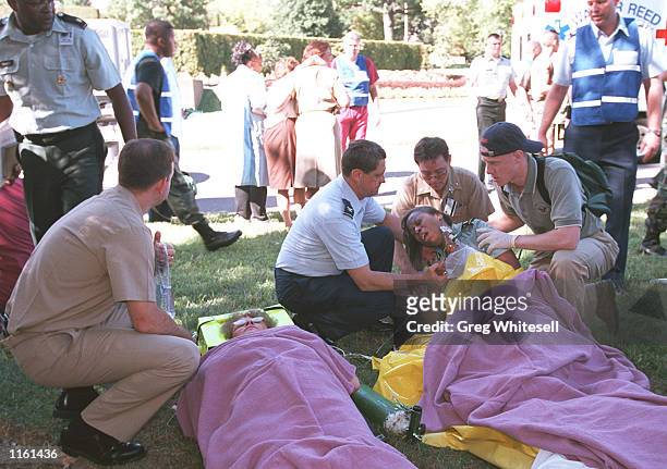 Recue workers and Pentagon personnel attend to the wounded outisde the Pentagon after a hijacked plane crashed into the building September 11, 2001...