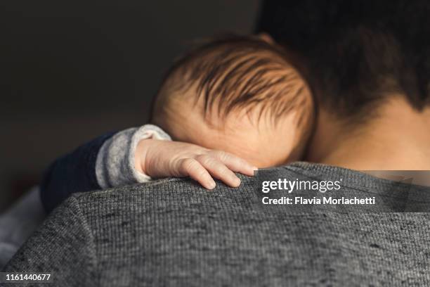 baby boy on dad's arms - father stock pictures, royalty-free photos & images
