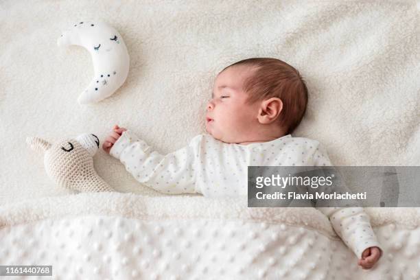 baby boy in bed sleeping with moon and llama - mini moon stock pictures, royalty-free photos & images