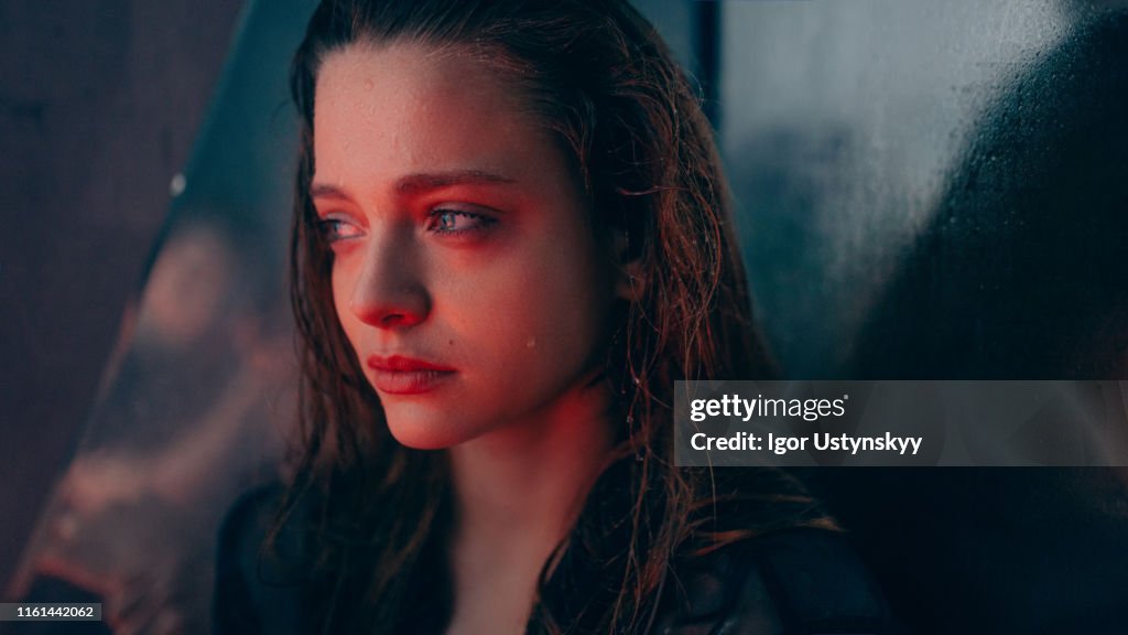 Conceptual portrait of young sad woman