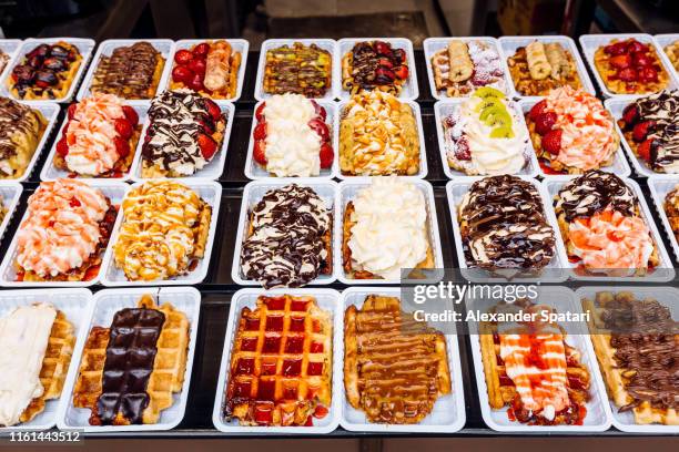 belgian waffles with various sweet toppings for sale, brussels, belgium - chocolate souffle stock-fotos und bilder